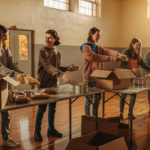 Students sorting canned goods into boxes for local food pantries in a Midwest school gym